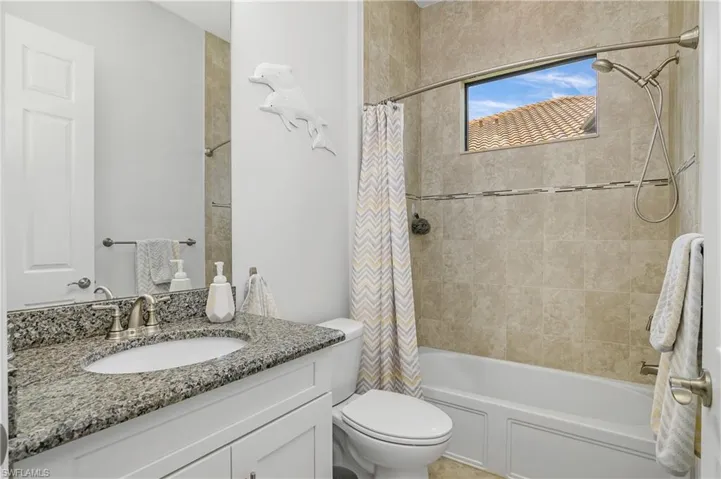 Guest bath with tub/shower combo.
