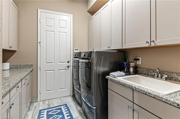 Laundry Rm w/Washer Dryer, sink, cabinets