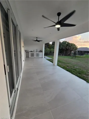 View of patio / terrace featuring a ceiling fan and exterior kitchen
