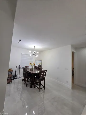 Dining area with suspended lighting and baseboards