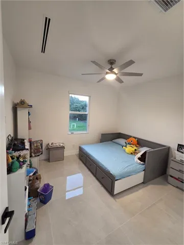 Bedroom featuring a ceiling fan and light tile patterned flooring