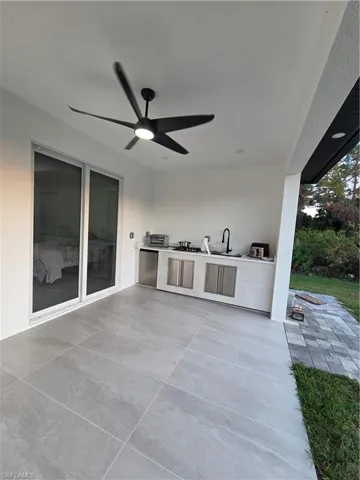 View of patio / terrace with an outdoor kitchen and a ceiling fan