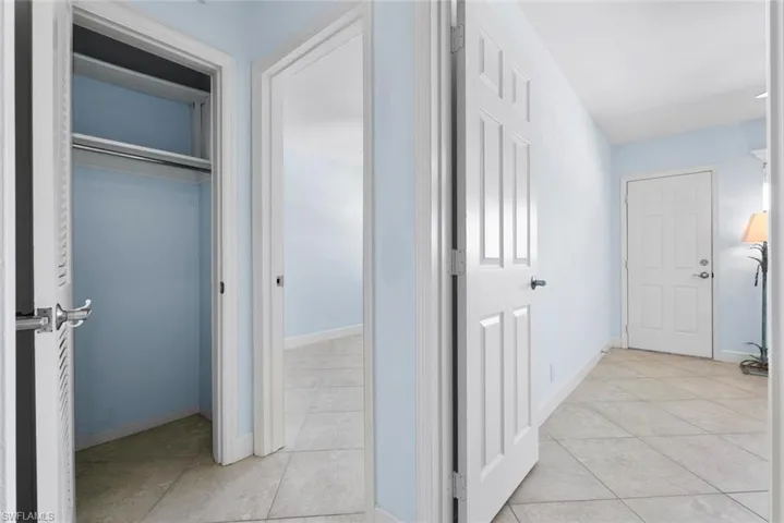 Corridor with light tile patterned floors