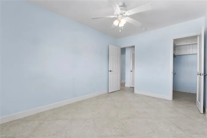 Unfurnished bedroom featuring ceiling fan