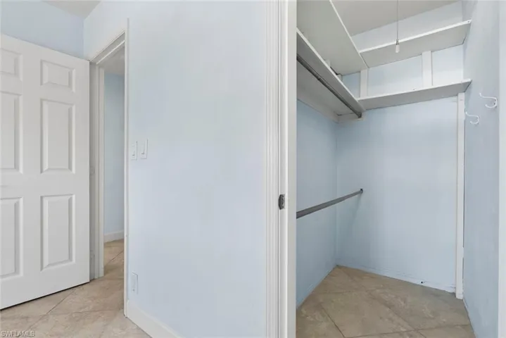 Spacious closet featuring light tile patterned flooring