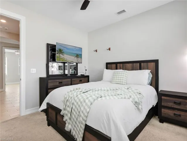 Bedroom featuring neutral wall paint, carpet flooring, a ceiling fan, and recessed lighting
