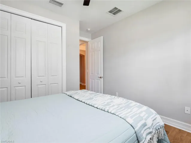 Room featuring a bi-fold closet, recessed lighting, ceiling fan, and wood-finish flooring