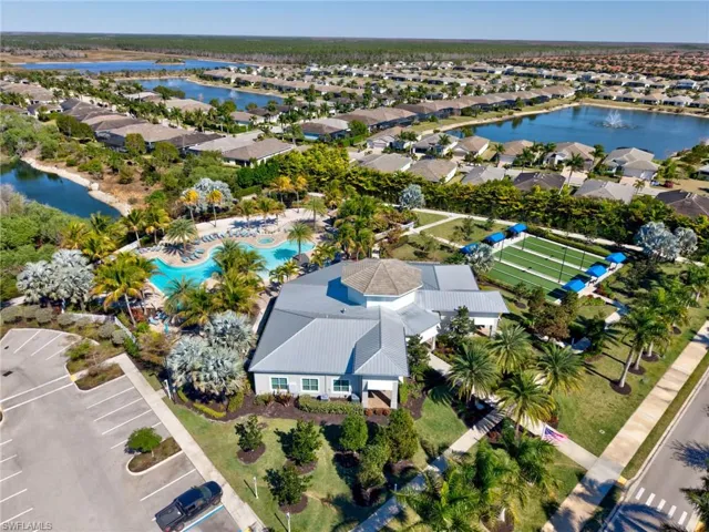 Community clubhouse with a resort-style pool, bocce ball courts, and a surrounding residential neighborhood with multiple lakes