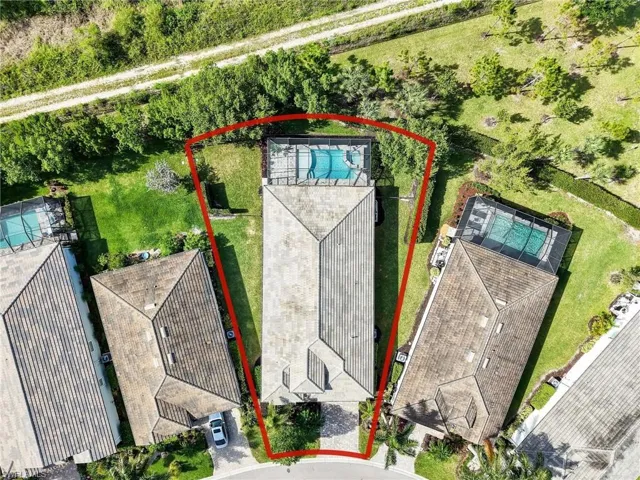 Aerial perspective showcasing the property's rectangular lot, featuring a private swimming pool with a screen enclosure
