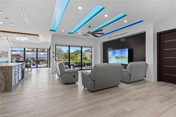Living room featuring ceiling fan and light hardwood / wood-style flooring