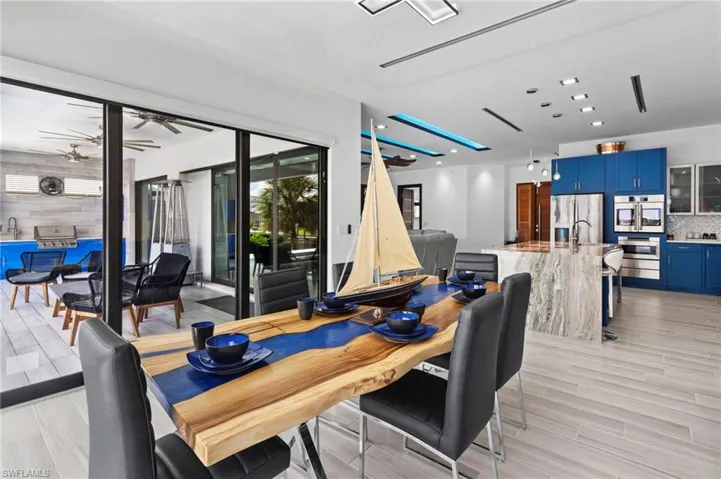Dining area with ceiling fan and light hardwood / wood-style flooring