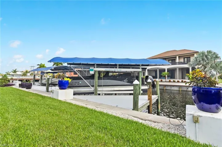 Dock area featuring a lawn and a water view