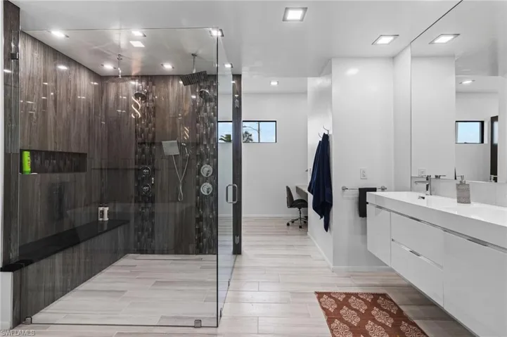 Bathroom with vanity, a shower with door, and hardwood / wood-style flooring