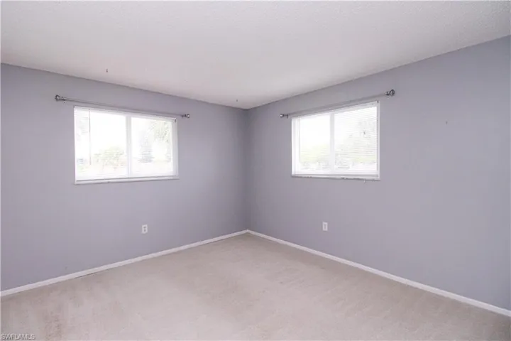 Empty room with carpet floors and plenty of natural light