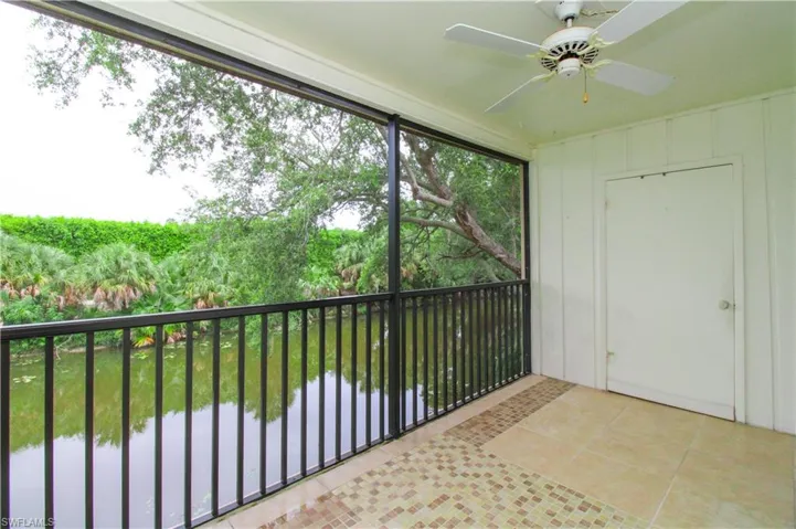Unfurnished sunroom featuring ceiling fan