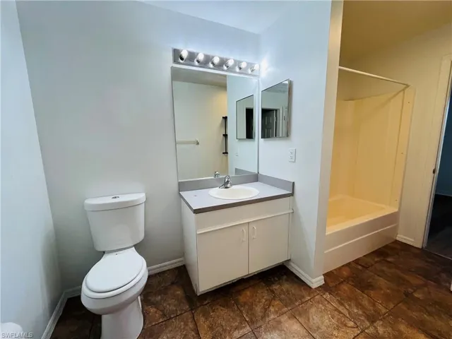 Full bath featuring vanity and shower / washtub combination