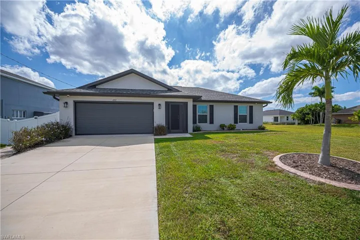 Single story home with stucco siding, concrete driveway, and an attached garage