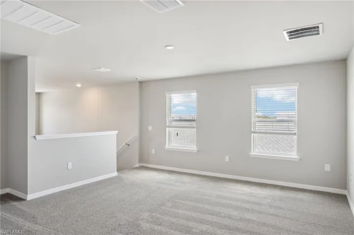 Unfurnished room featuring carpet floors and baseboards