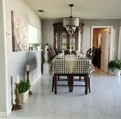 Tiled dining area with a notable chandelier
