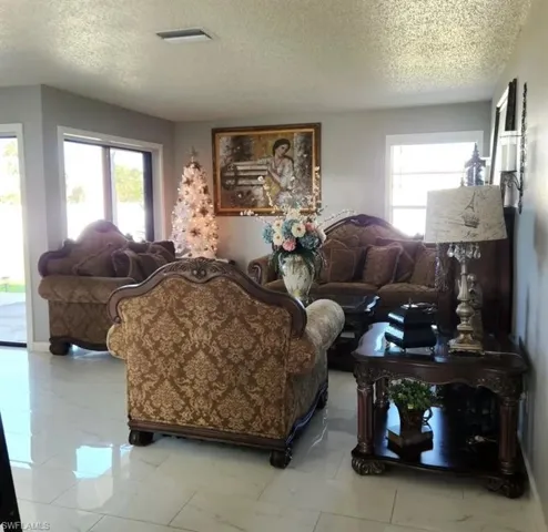 Tiled living room with a textured ceiling