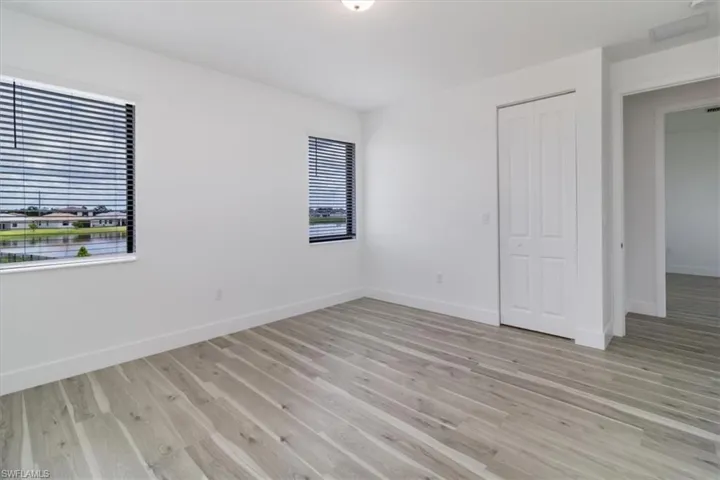 Bedroom 4 featuring light wood-style floors/ in suite BR