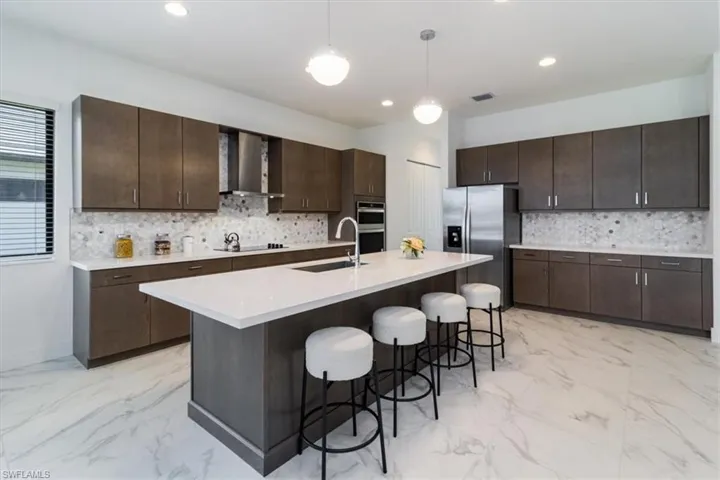 Upgraded kitchen quartz countertops, wall chimney range hood