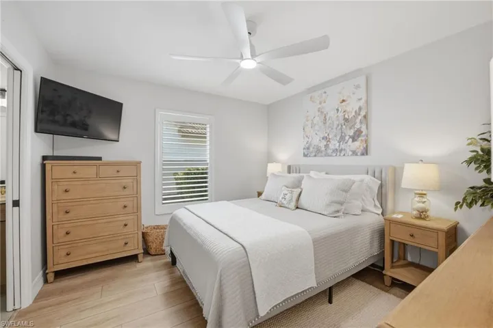 Comfortable guest bedroom with natural light from plantation shutters