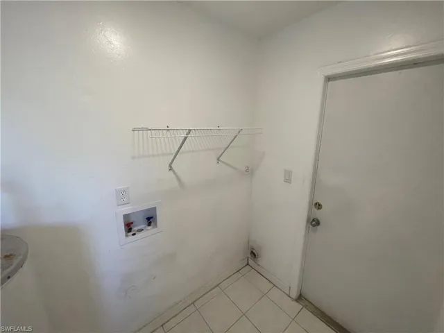 Washroom featuring light tile patterned floors and washer hookup
