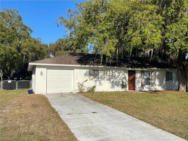 Single story home with stucco siding, concrete driveway, an attached garage, and roof with shingles