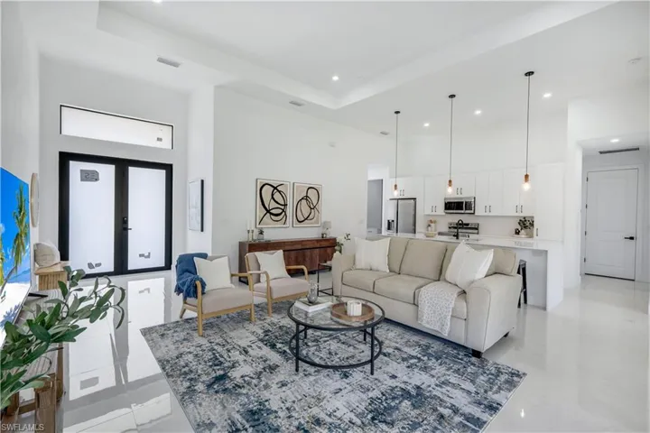 Living area featuring a high ceiling and recessed lighting
