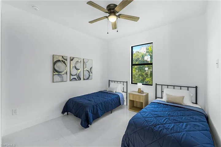 Bedroom with a ceiling fan and baseboards