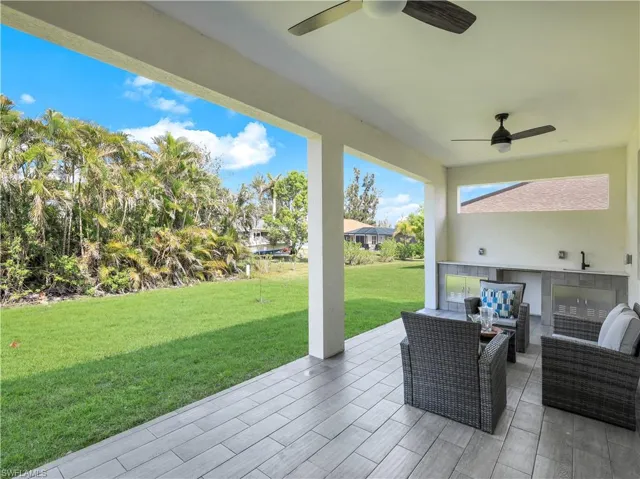 View of patio with ceiling fan, exterior kitchen, an outdoor hangout area, and a sink