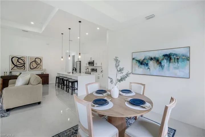 Dining room with recessed lighting, a high ceiling, and light tile patterned floors