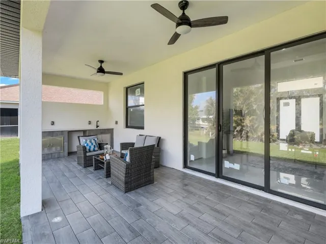 View of patio / terrace with a ceiling fan, area for grilling, and an outdoor living space