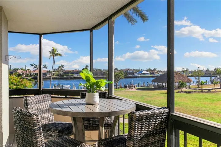 Sunroom featuring a water view