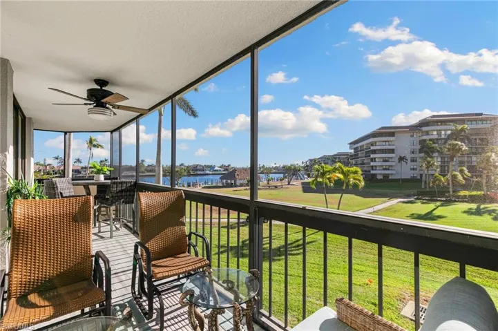Sunroom / solarium with a water view and ceiling fan