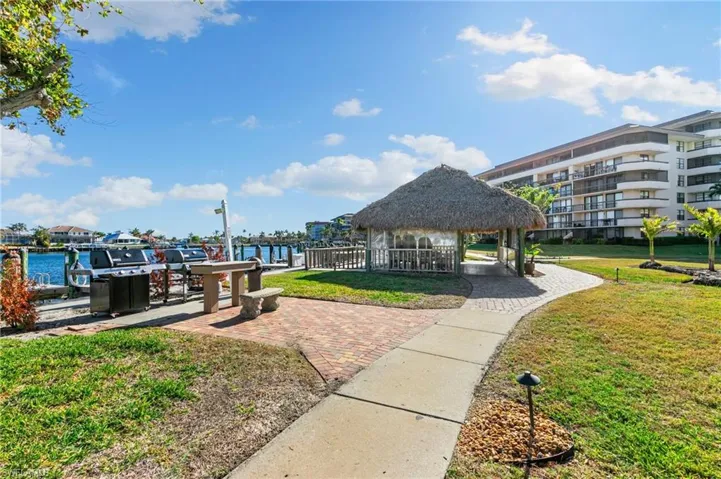 View of property's community featuring a gazebo, a lawn, and a water view