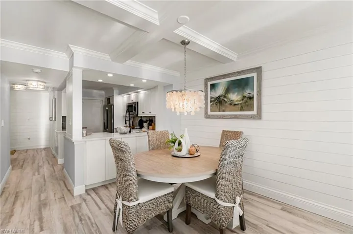 Dining room featuring wooden walls and light hardwood / wood-style flooring
