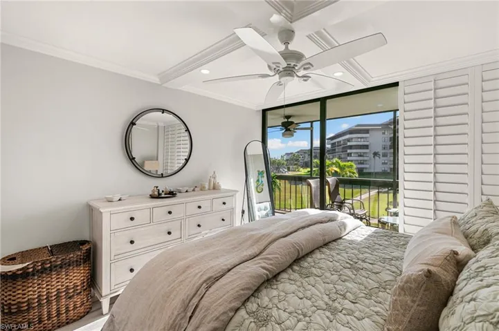 Bedroom featuring floor to ceiling windows, ceiling fan, beamed ceiling, access to outside, and ornamental molding
