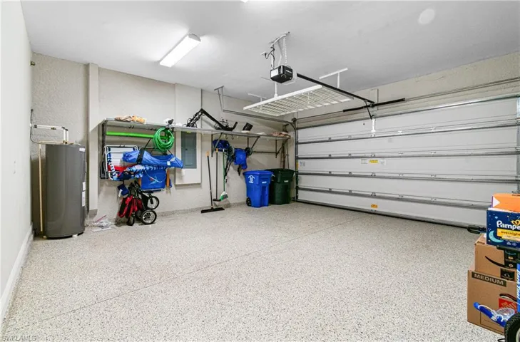 LARGE 2 CAR GARAGE WITH EPOXY FLOORING, HANGING STORAGE RACK & A NEWER HOT WATER HEATER (MAY OF 2022).