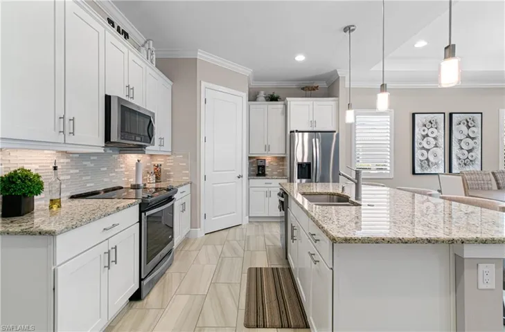 JUST PICTURE YOURSELF ENTERTAINING IN THIS AMAZING KITCHEN WITH PLENTY OF WHITE CABINETS & RECENTLY ADDED PENDANT & CAM LIGHTING!