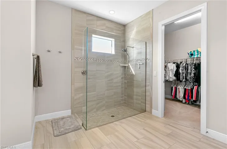 BEAUTIFULLY UPDATED WALK-IN GLASS SHOWER WITH TILE FLOORING!