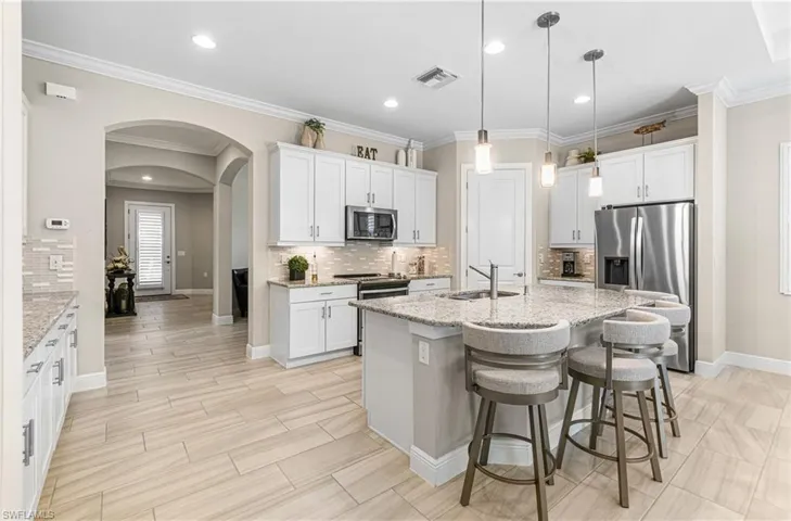 HUGE KITCHEN WITH BRIGHT LIGHTING & THE UPDATED 12 X 24 TILE FLOORING IS EVEN MORE BEAUTIFUL IN PERSON! SIMPLY AMAZING!