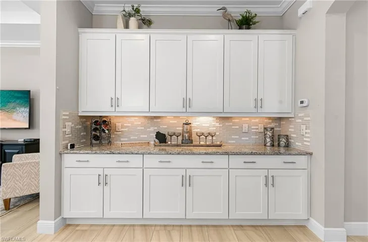 PRIVATE BAR AREA WITH EVEN MORE CABINETRY & BEAUTIFUL GRANITE COUNTER TOP, BACKSPLASH, SOFT-CLOSE DRAWERS & UNDER-MOUNT LIGHTING! THIS HOME HAS IT ALL.