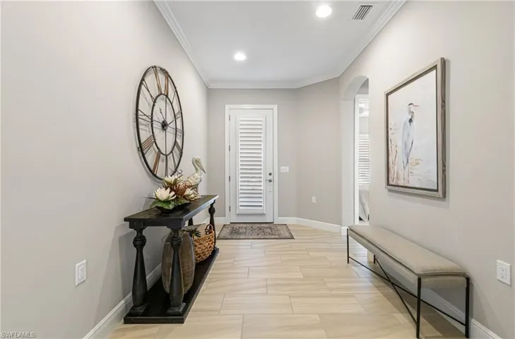 ENTRYWAY WITH BEAUTIFUL & MODERN 12 X 24 TILE FLOORING, PLANTATION SHUTTERS THROUGHOUT THE HOME & EVEN PLANTATION BLINDS ON THE FRONT DOOR!