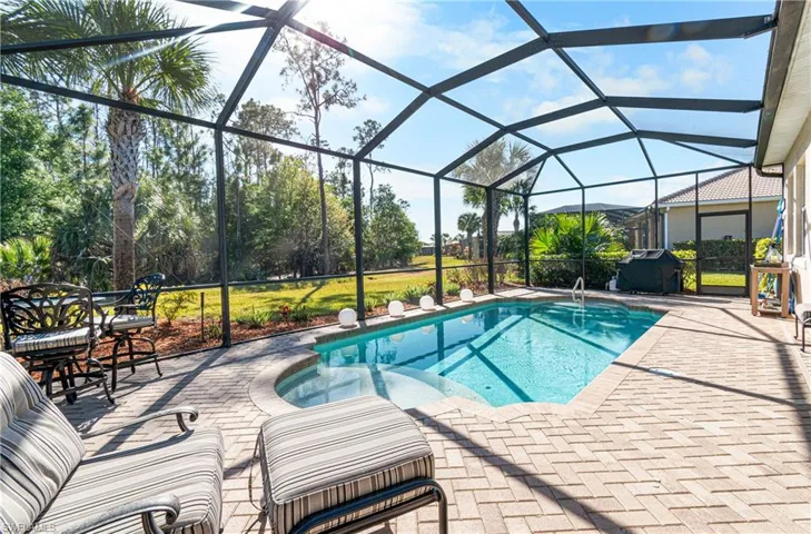 BEAUTIFUL POOL WITH A PAVERED DECK & EVEN INCLUDES A LARGE WEBER GRILL.