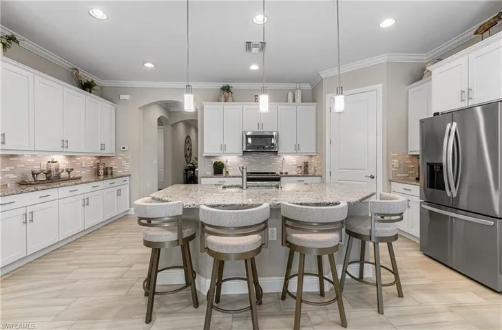NEW STAINLESS STEEL REFRIGERATOR & DISHWASHER ARE 2024 PLUS THOSE BEAUTIFUL & MODERN BARSTOOLS REMAIN WITH THE HOME!