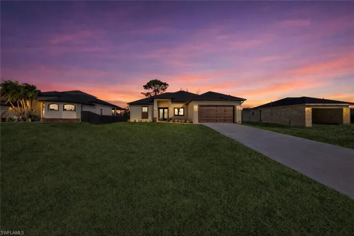 Prairie-style house with driveway and an attached garage
