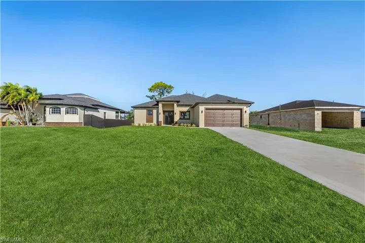 Prairie-style house featuring driveway and a garage