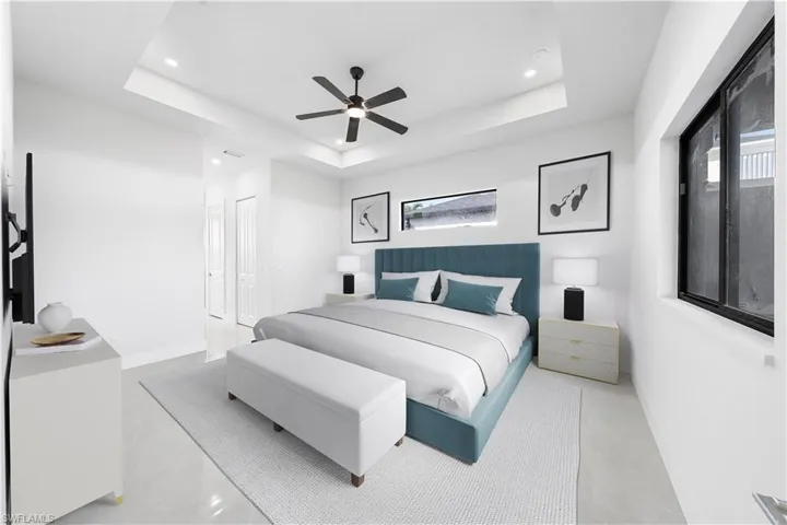 Bedroom with a raised ceiling, ceiling fan, recessed lighting, and finished concrete flooring